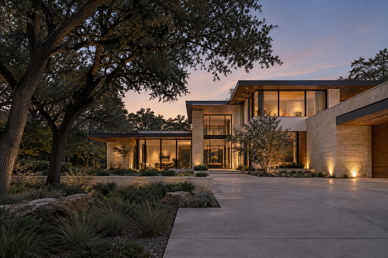 Illustrative contemporary residence with limestone planes, warm interior light, and mature oak landscaping